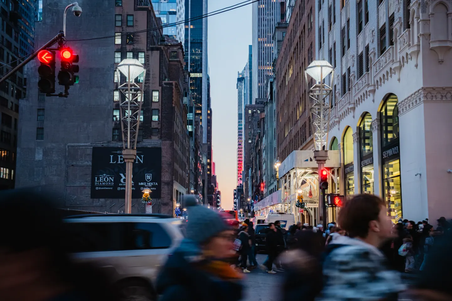 People and vehicles moving through a New York City street